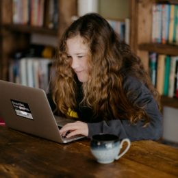 Young girl looking at laptop