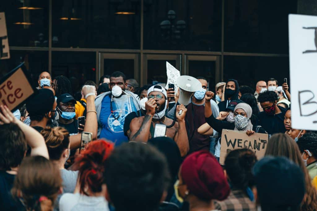 Activist speaking to a crowd with a megaphone