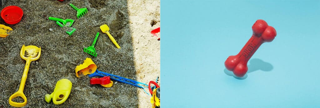 Plastic red dog toy on a blue background. Plastic kids toys seen in a sandbox or on the beach.