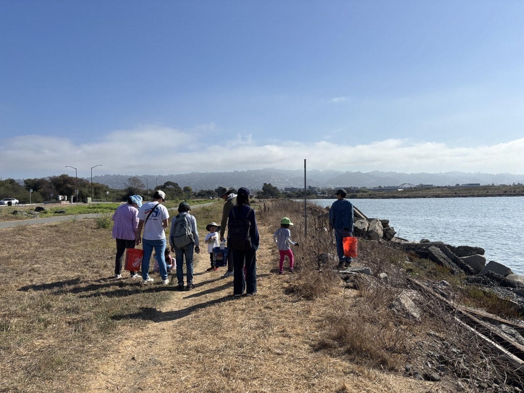 Volunteers pick up trash among the coast
