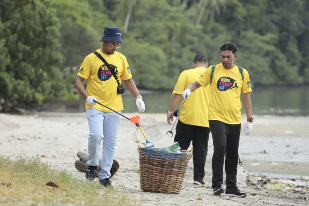 Volunteers clean up trash on the beach on Penang Island